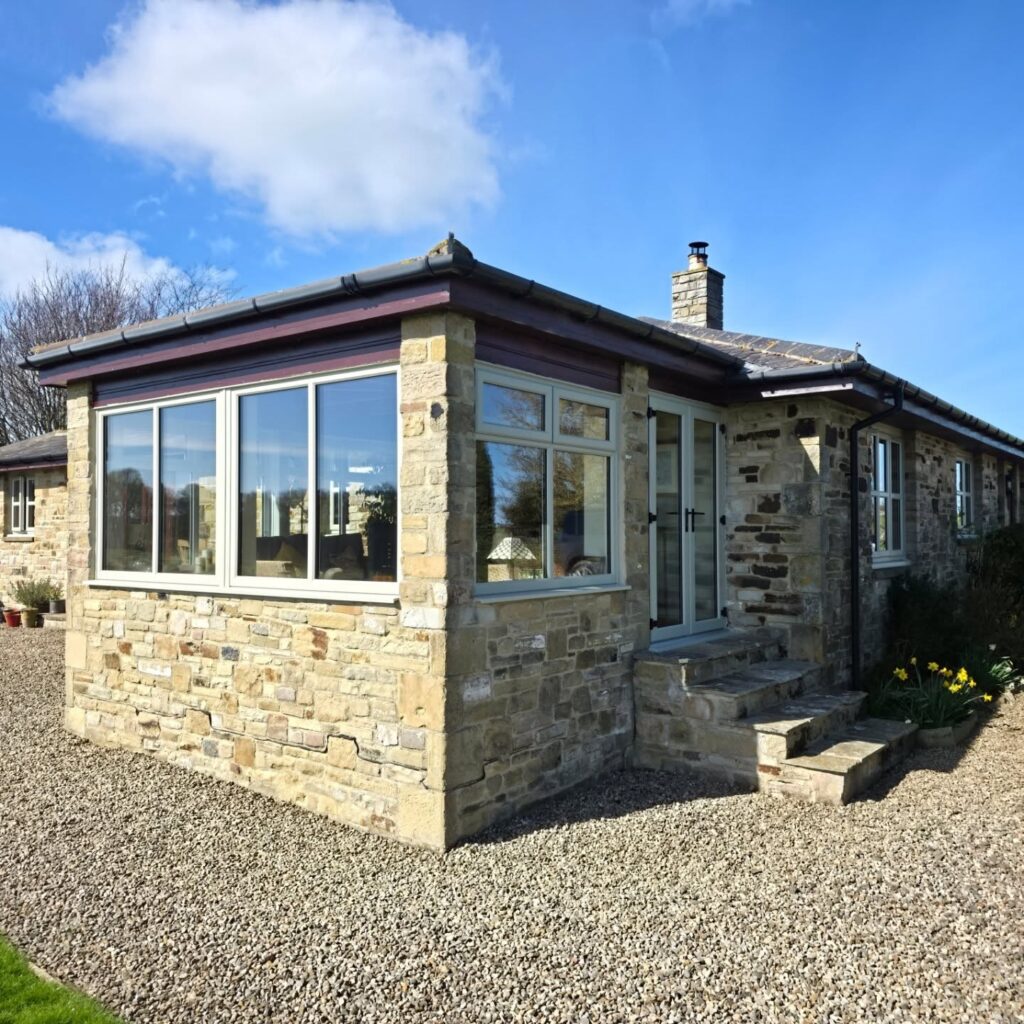 New REHAU Total70 window frames in Pebble Grey with 44mm triple glazing fitted to a house conservatory near Hexham