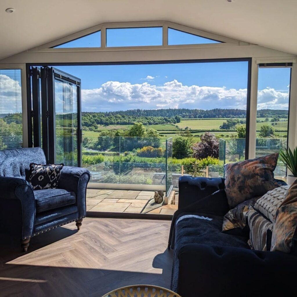 Closed aluminium bi-fold doors with full-height glass overlooking the garden